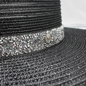 Elegant black straw hat with sparkling rhinestones and a metallic silver M emblem