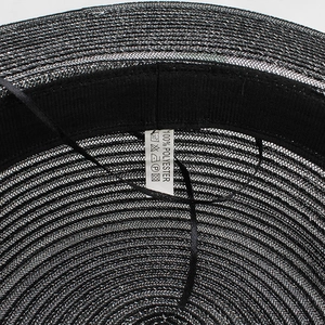 Interior view of black woven straw sun hat with polyester band and sweatband detail