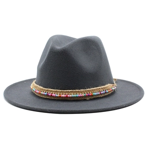 Close-up of the grey fedora hat with bohemian style beads, twine, and rhinestone trim
