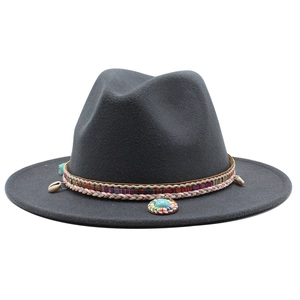Detail of dark grey wool fedora with ethnic band, woven cord and turquoise shell charm