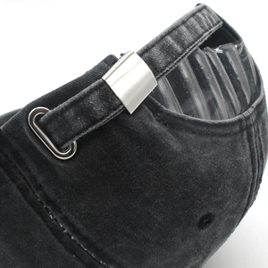 Macro detail of cotton baseball cap with adjustable metal slider buckle and washed fabric