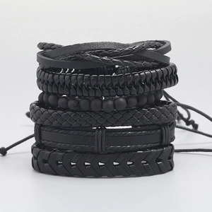 Set of six vintage black braided leather bracelets with various bead and weave textures