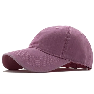 Close-up of a dusty pink washed cotton baseball cap featuring high-quality stitching detail