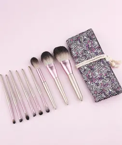 Detail showing 10-piece gradient makeup brush set with a purple floral roll-up pouch