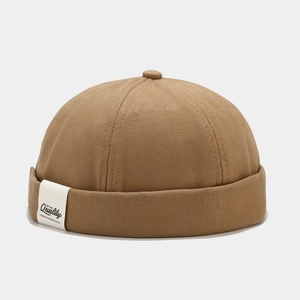 Detailed macro view of khaki sailor cap fabric texture and vintage woven side label
