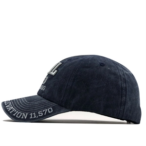 Detail of navy washed cotton baseball cap with white 3D Colorado embroidery and brim text