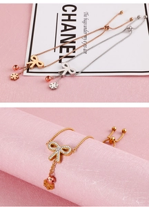 Detail of adjustable butterfly bracelets in rose gold and silver with zircon charms
