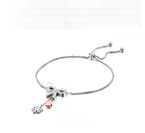 Detailed view of butterfly charm with cubic zirconia and snowflake on a steel chain