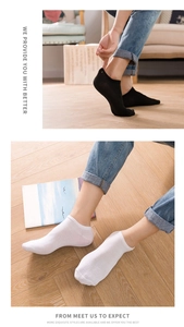 Close-up of low-cut cotton socks in black and white with reinforced ribbed cuffs
