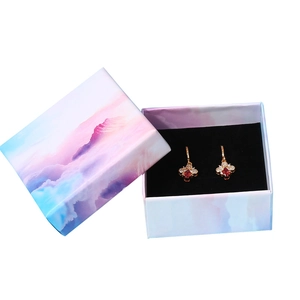 Golden bee earrings with red zircon in a colorful cloud pattern jewelry gift box
