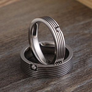 Titanium steel couple rings with striped patterns and single diamond in silver-grey finish
