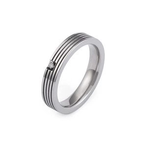 Sleek stainless steel ring with black striped grooves and a centered cubic zirconia stone