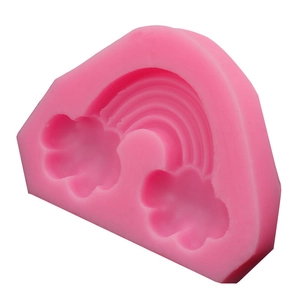 Macro detail of a pink silicone mold featuring a rainbow and small cloud shapes