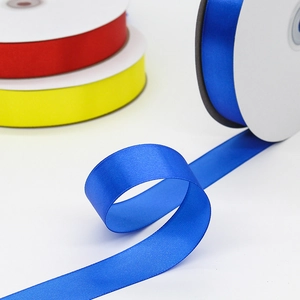 Vibrant blue polyester satin ribbon rolls for gift wrapping and decorative crafts