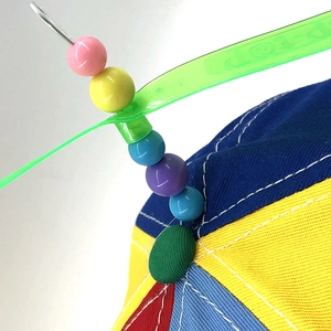 Rainbow propeller hat with colorful beads and rotating blades on a baseball cap top