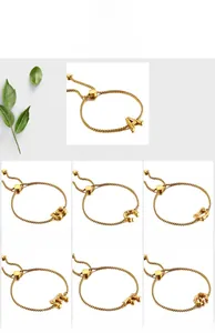 Detail of adjustable gold initial bracelets with bamboo texture and heart charms