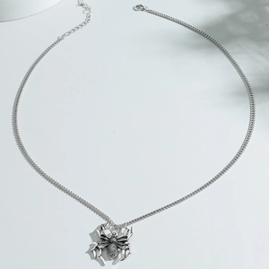 Gothic silver spider pendant necklace with detailed Cuban link chain on white background