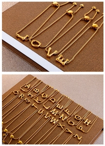 Detail of adjustable gold stainless steel bracelets showing LOVE and A-Z letter charms