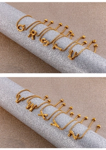 Detailed view of gold stainless steel box chain bracelets with alphabet charms Q to Z
