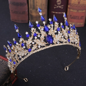 Baroque gold bridal crown with royal blue rhinestones and intricate hollow floral patterns