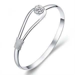 Detailed close-up of a silver rose flower bracelet with elegant braided texture