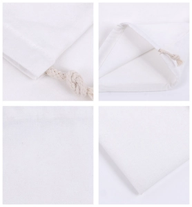 Close-up of white canvas drawstring bag showing fabric texture and sturdy stitched knots
