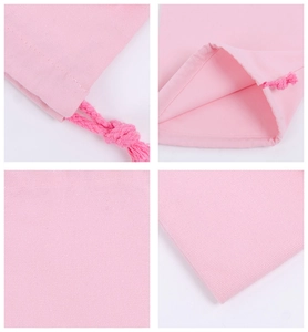 Detail of pink cotton drawstring bag showing stitching and woven fabric texture