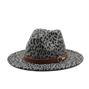 Detail of grey leopard print fedora hat featuring a brown leather band and silver metal buckle