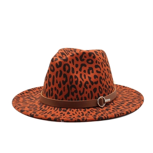 Close-up of leopard print fedora with brown leather band and silver metal buckle detail