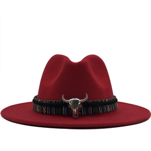 Détail d'un chapeau en laine bordeaux avec ruban ethnique et ornement de crâne de buffle