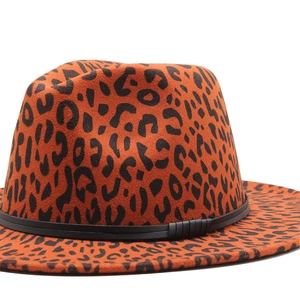 Close-up of leopard print fedora hat with black leather band showing wool texture