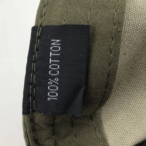 Macro detail of 100% cotton material tag and stitching on olive green army cap