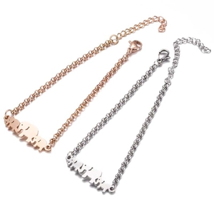 Detailed macro view of elephant charms on rose gold and silver stainless steel bracelets