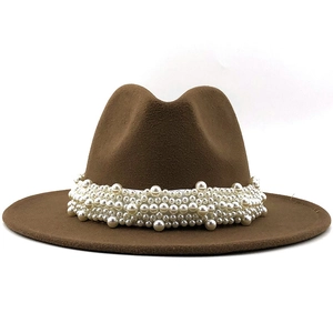 Detail of brown wool fedora hat featuring elegant white pearl embellishments on the brim