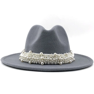 Close-up of elegant grey wool felt fedora hat featuring luxury white pearl embellishments