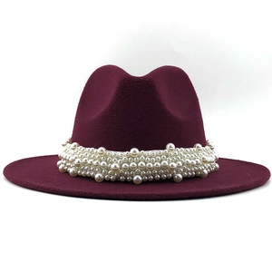 Close-up of elegant burgundy wool fedora hat featuring detailed white pearl band decoration