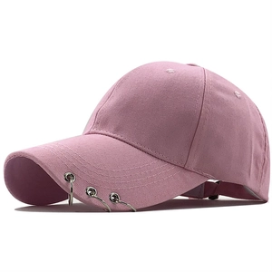 Pink cotton baseball cap featuring silver rings on brim and adjustable strap closure