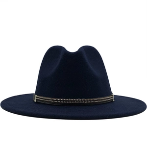 Detail of dark blue fedora hat featuring a brown band with double-row metal rivets