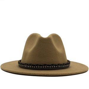 Detail of camel wool fedora hat featuring a braided leather band with sparkling rhinestones