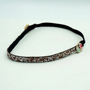 Sparkling rhinestone headband with floral wooden buttons for ear protection on grey background