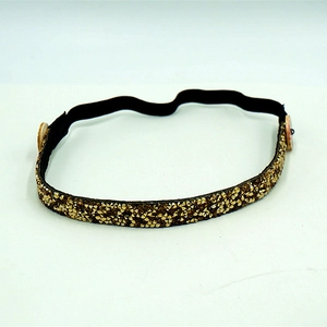 Detailed view of golden rhinestone headband with buttons for mask ear relief