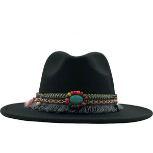 Detail of black wool fedora with ethnic woven band, turquoise stone, and grey fringe trim