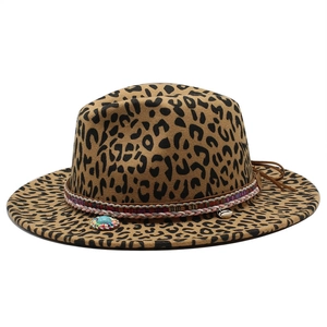 Detail of leopard print fedora hat featuring ethnic woven band and turquoise pendant