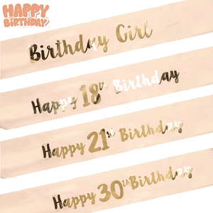 Detail of rose gold birthday girl sashes with metallic gold text for 18th 21st 30th parties