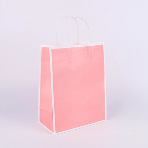 Close-up of pink kraft paper shopping bag with white border and sturdy handles