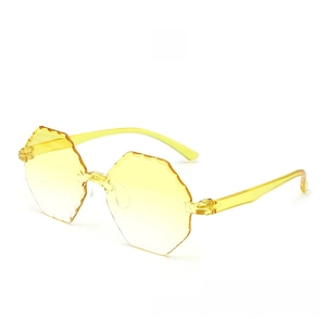 Detail of yellow rimless sunglasses with geometric edge-cut lenses and transparent frame