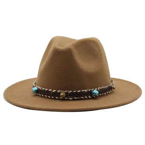 Detail of coffee wool fedora hat featuring woven band with turquoise beads and gold studs