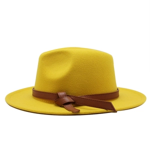 Detail of yellow wool fedora hat with wide brim and brown leatherette knot band