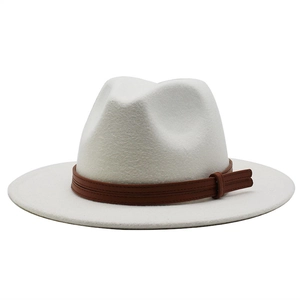 Detail of white wool fedora hat with a brown faux leather band and double stitching