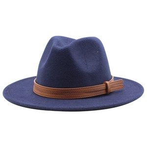 Detailed view of dark blue fedora hat with brown leather band and metal buckle detail